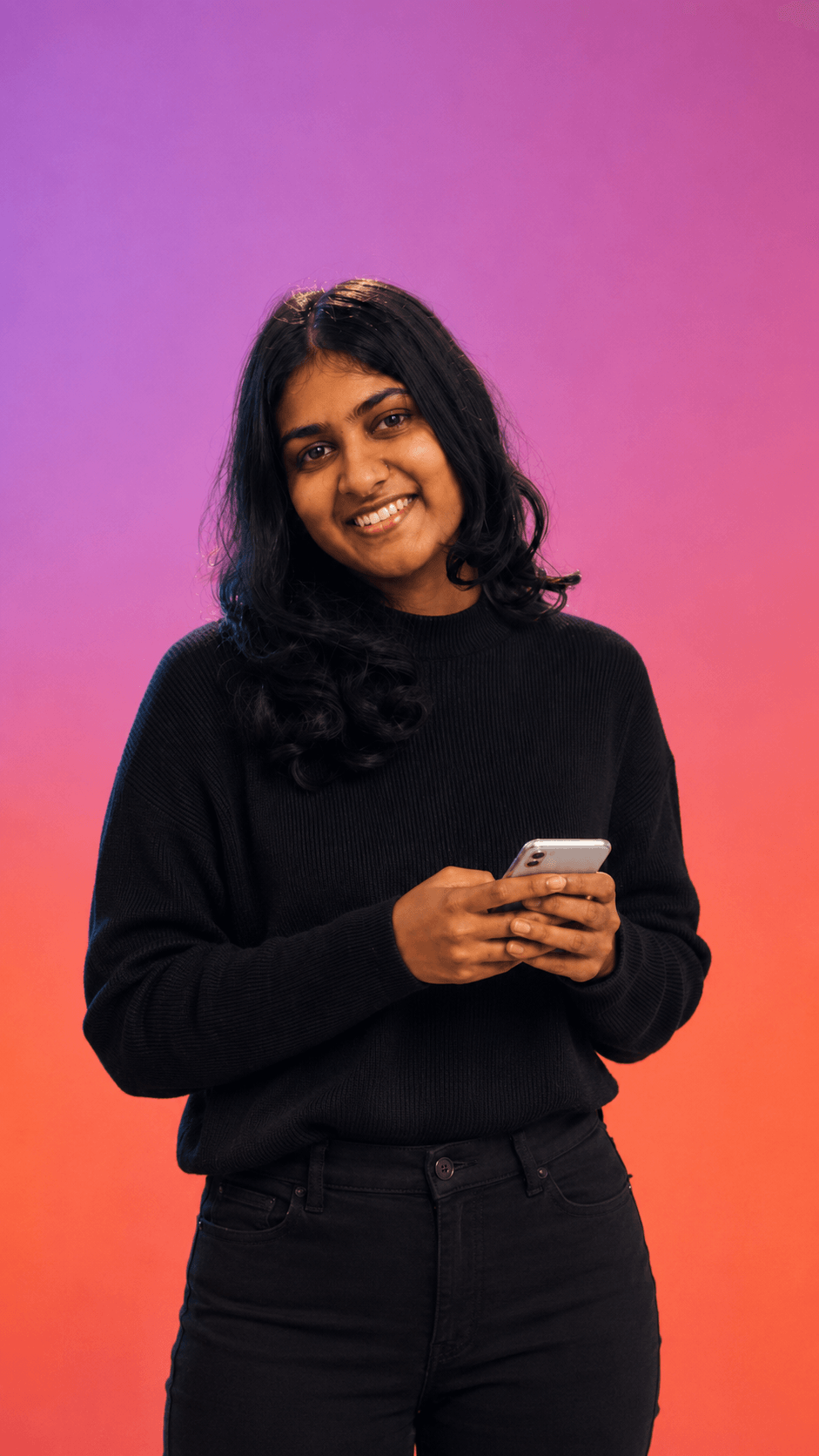 Upeksha Deshapriya, standing with her phone
